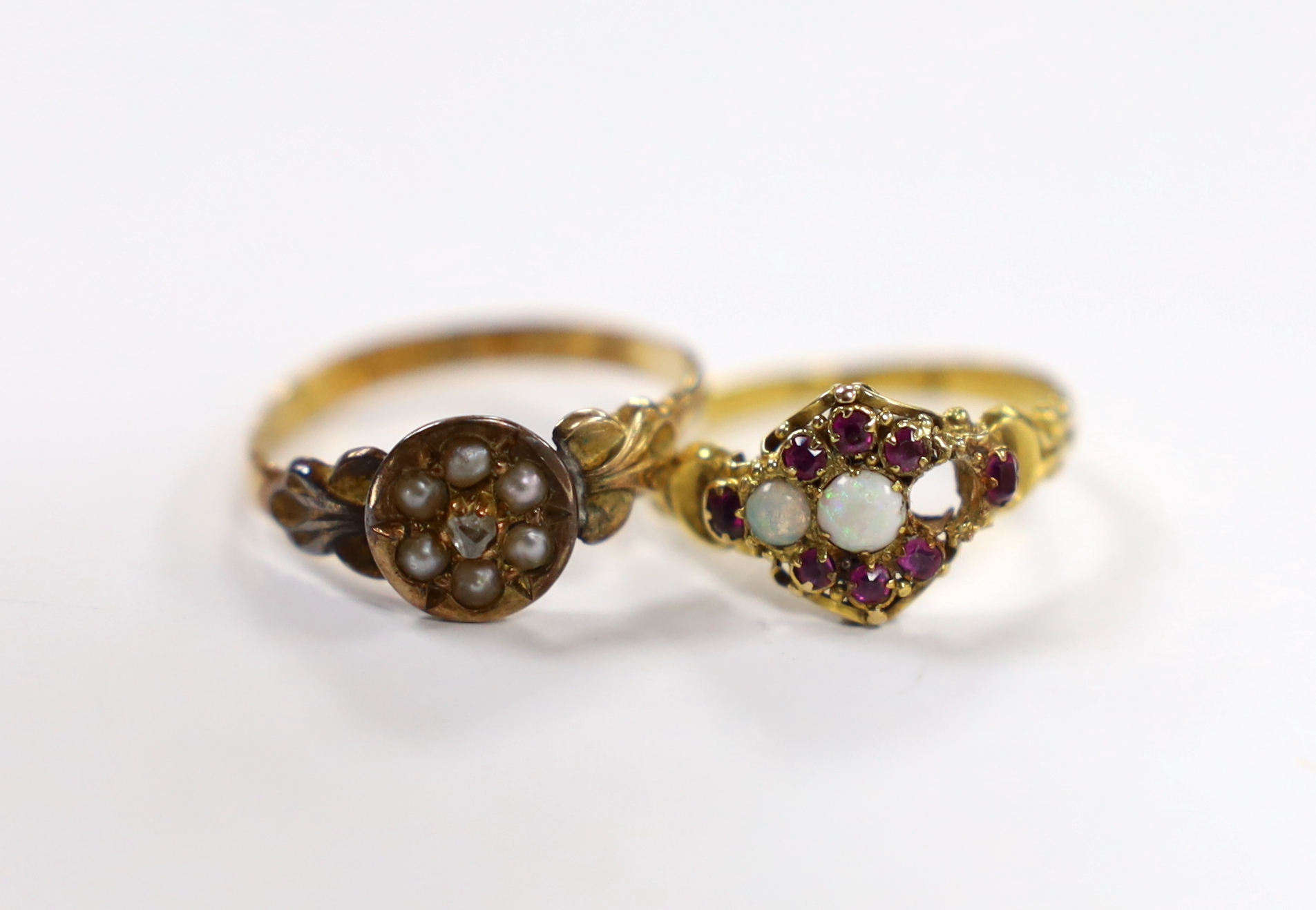 A Victorian 18ct gold, white opal and garnet cluster set dress ring, (opal missing), size J/K, gross weight 1.9 grams and a 15ct gold, seed pearl and rose cut diamond cluster set ring gross weight 1.7 grams.